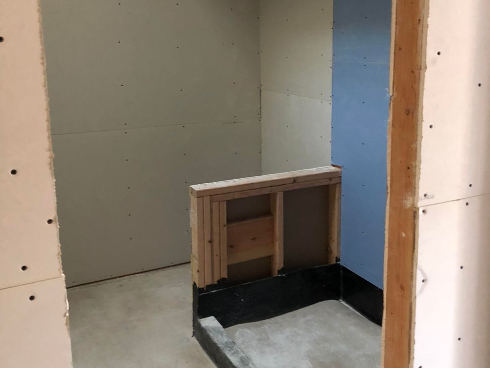 benefits working with licensed general contractor - Bridgeview Construction The inside of a home with walls that have holes in them.