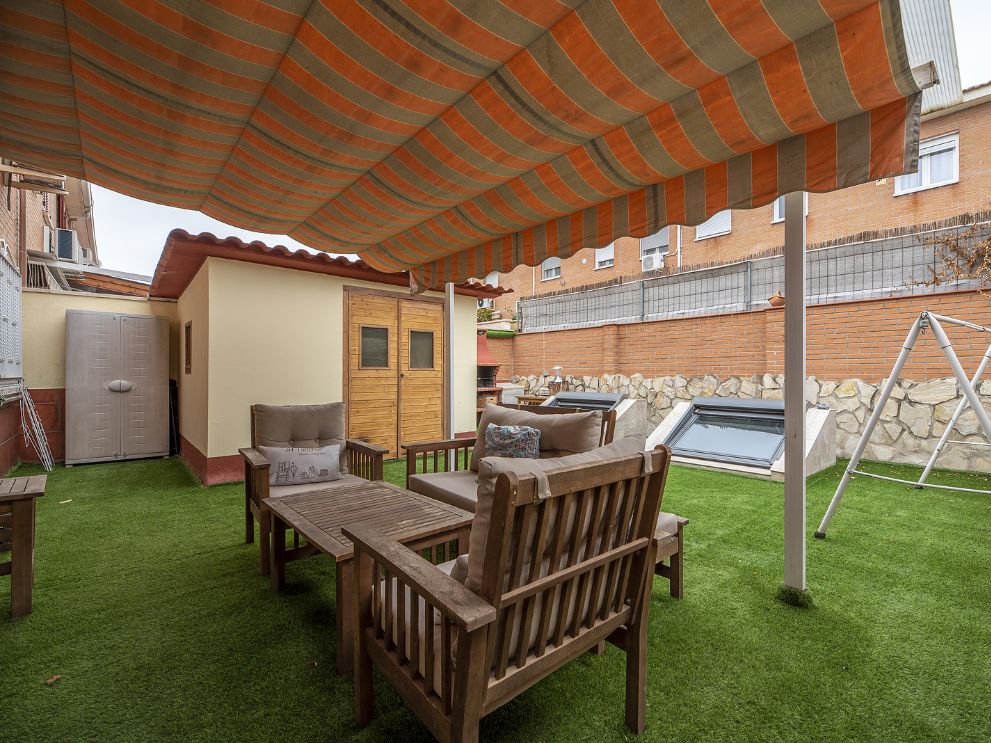 ADU (accessory dwelling unit) in a backyard underneath a wood patio cover
