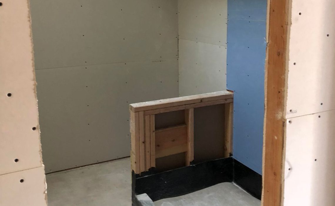 The inside of a home with walls that have holes in them.