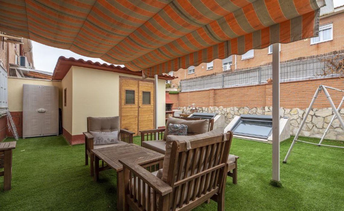 ADU (accessory dwelling unit) in a backyard underneath a wood patio cover