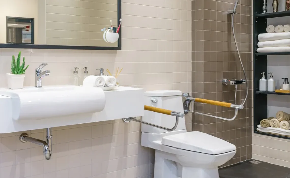 A bathroom with a toilet, a sink, a mirror and a shower.