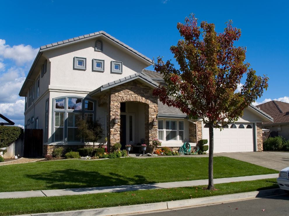 planning exterior home remodel adds value curb appeal - Bridgeview Construction A view of the front exterior of a home. There is a tree in front of the home.