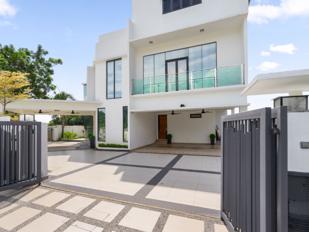 The outside of a home that has a balcony and a garage.